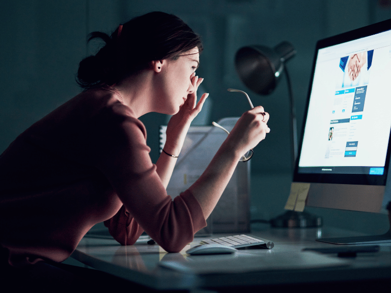 woman staring at screen, a need to cut down on evening screen time to adjust sleep schedule