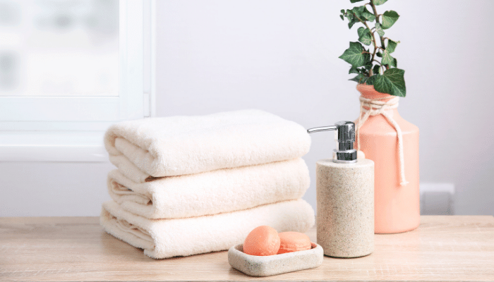 towel, soap and body wash in a shower