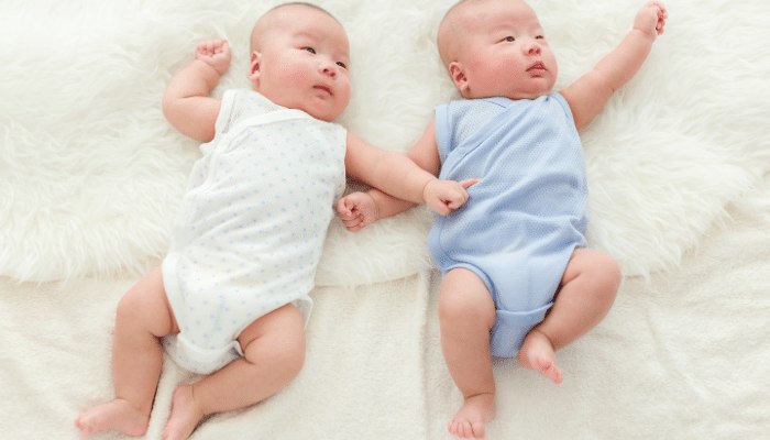 two babies next to each other 
dream about giving birth