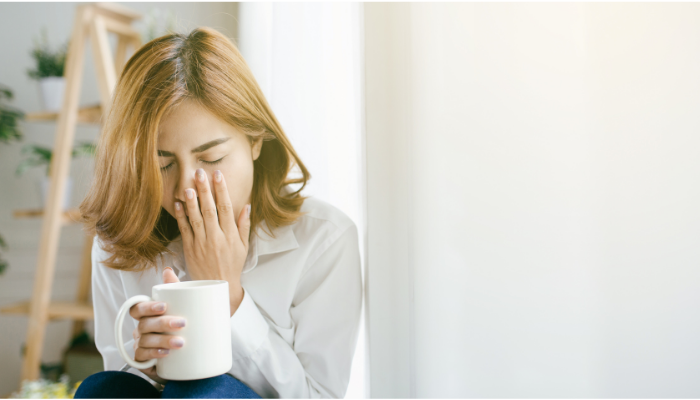 woman sitting with a mug in hand