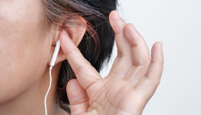 women holding earphone 