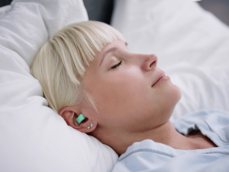 woman wearing headphones or earplugs, sleep with someone who snores