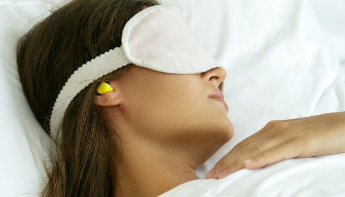 women wearing soft earplugs for sound sleep