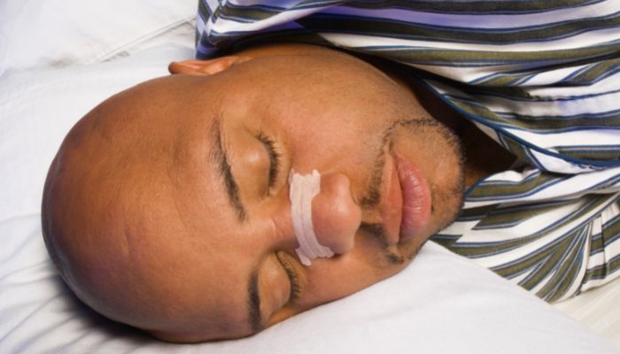 person sleeping with nasal strips