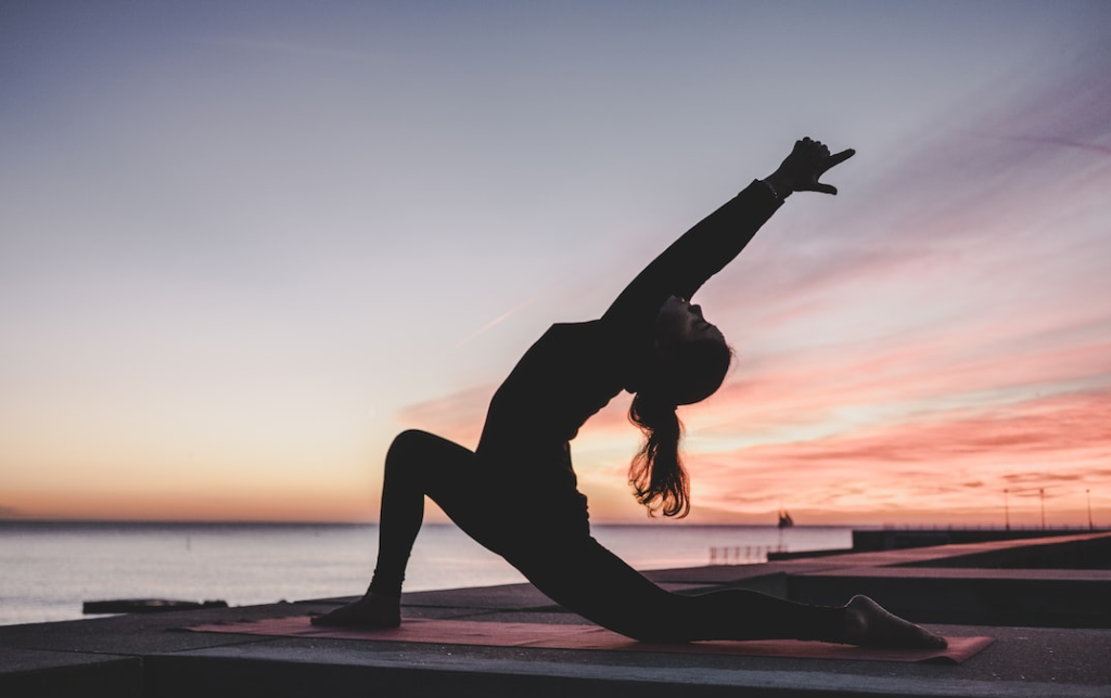 women doing exercise during sunrise