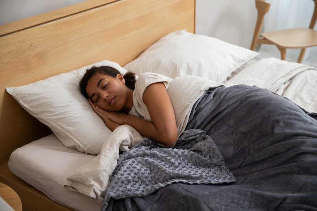 a woman laying in bed with her head on a pillow
