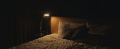 table lamp turned on near bed
