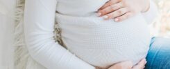 pregnant woman in white long sleeve shirt