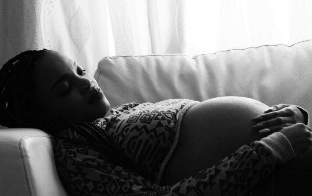 pregnant women lying in couch