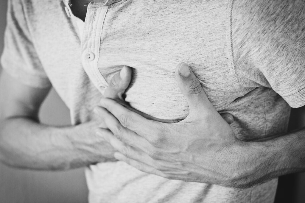 man in pain holding chest