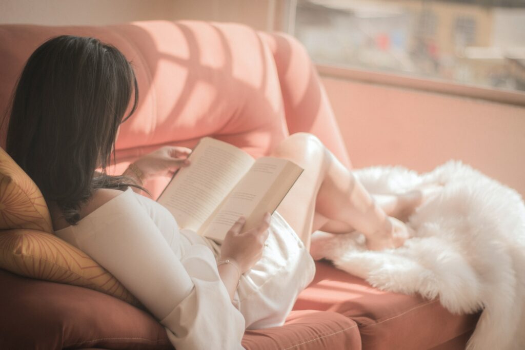women reading book in sofa