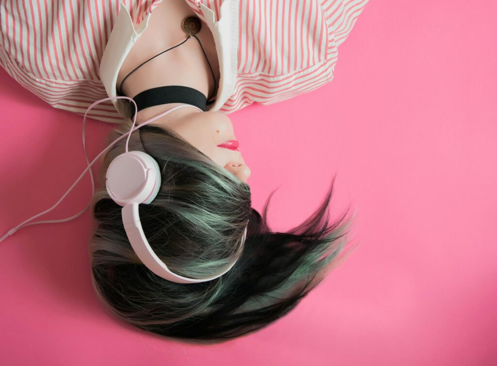 woman covering her hair and wearing headphones
