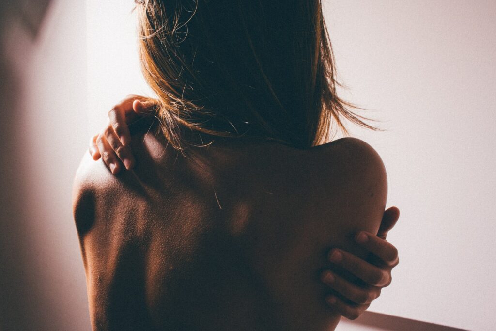 women holding her backside in pain