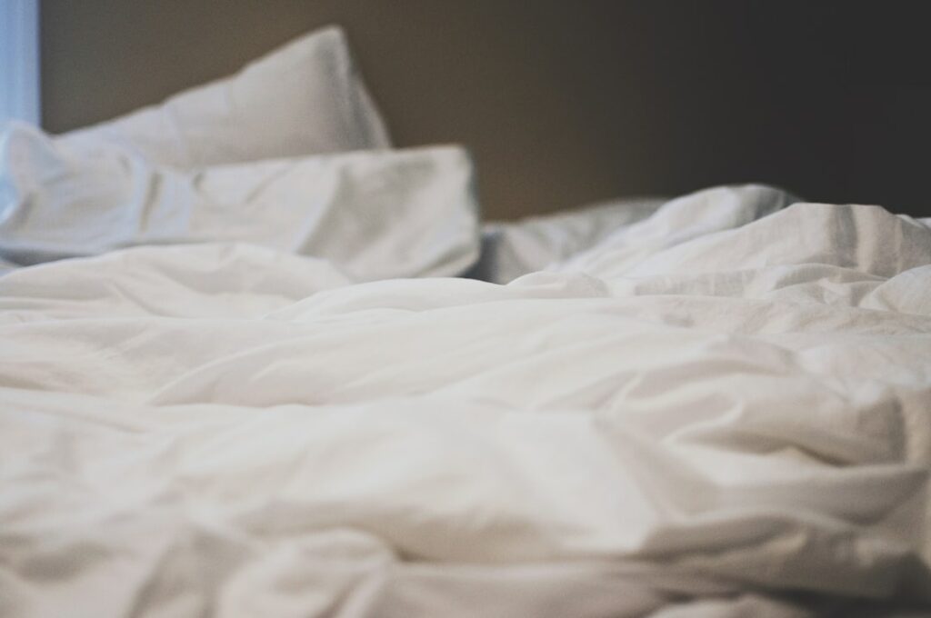 white blanket in bed
