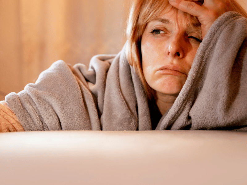 woman looking tired and restless, a result of sleeping with head in the north direction