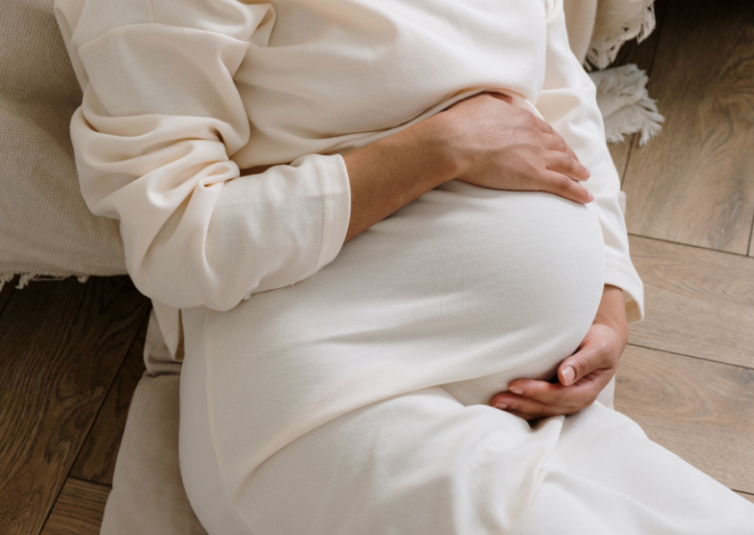 pregnant woman holding belly
