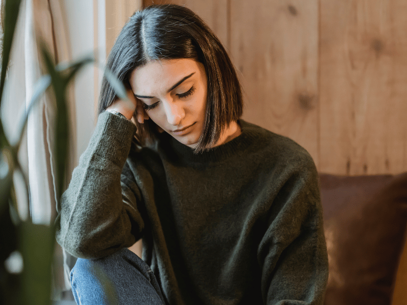 woman closing eyes and sleeping during daytime which is a common symptom of dyssomnia