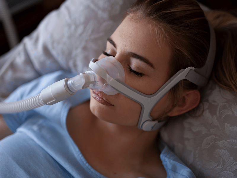 woman sleeping with a cpap mask attached