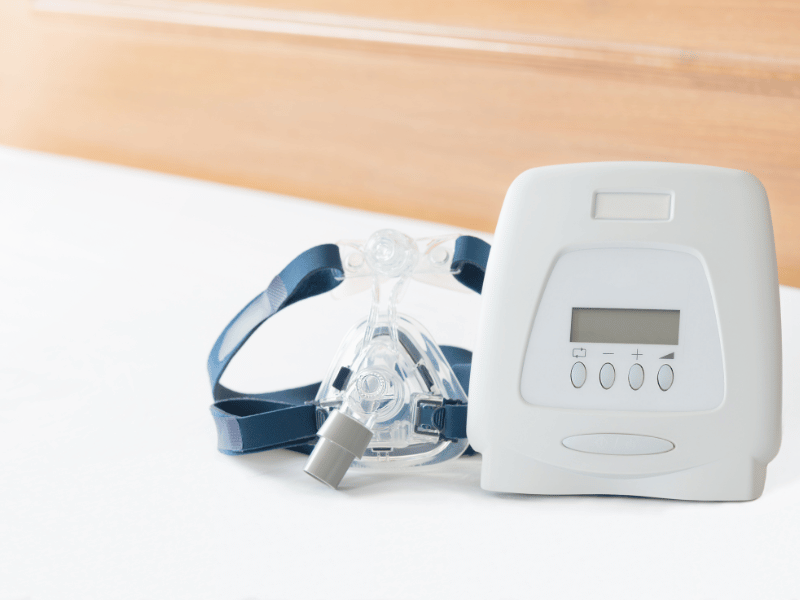 Sleep apnea machine with face mask behind