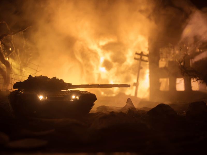 shadow of military tank against a backdrop of fire and destruction, what it means to see a war in dreams