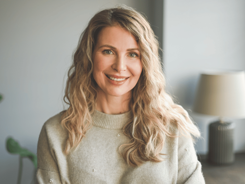 An aging woman with long blonde hair, highlighting the importance of sleep for women's health and well-being.