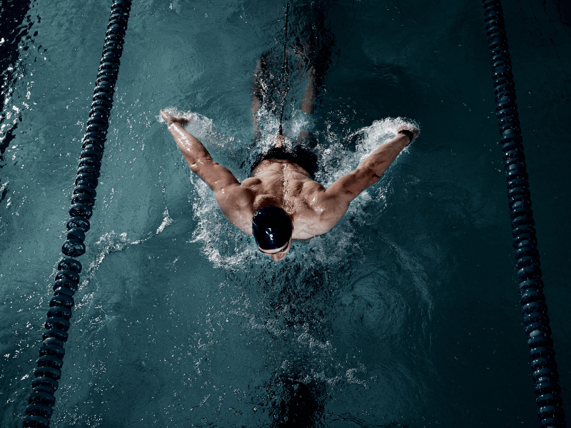 man with black swimcap, swimming in the water, what does it mean when you dream of swimming